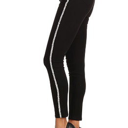 model showing side view of striped jeans in black with a rhinestone trim