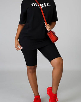 bike shorts set in black modeled with red bag and red sneakers