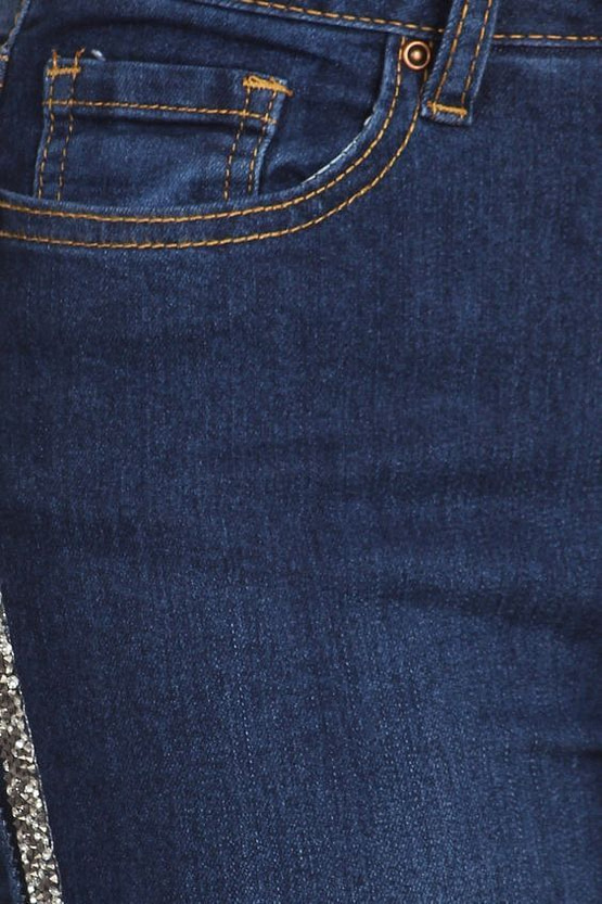 close up view of rhinestone trim of stripe jeans